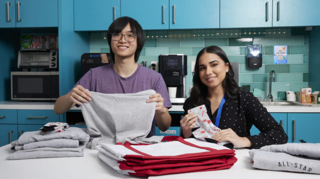 Two volunteers placing CTBC blood donor giveaways in a bog.