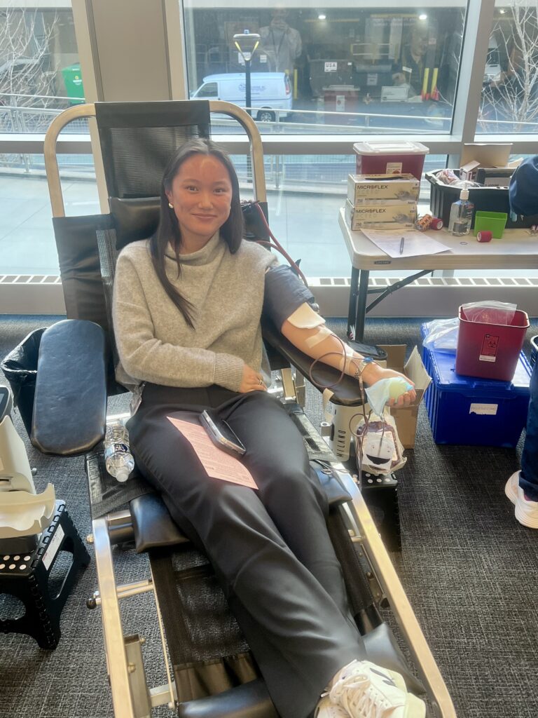 Smiling blood donor in donation chair at Alexion Blood Drive.